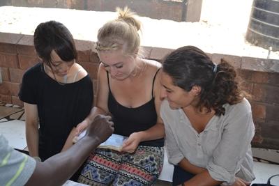 Volunteers check blood samples during a medical outreach in Accra Projects Abroad Medical HIV/AIDS volunteers checking blood samples together during a medical outreach in James Town, Accra