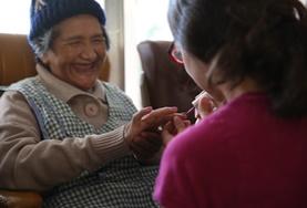 Bolivia A Care volunteer gives a manicure to a woman during an outreach at an elderly home in Bolivia.
