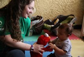 Costa Rica A volunteer plays with a child using a soft toy at our Care placement in Costa Rica.