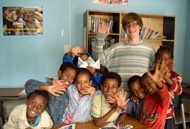 Ethiopia Local children and a childcare volunteer wave their hands after a lesson at our placement in Ethiopia.