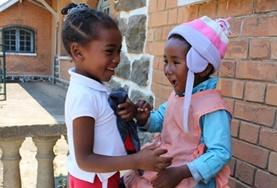Madagascar Two children laugh together at one of our childcare placements in Madagascar.