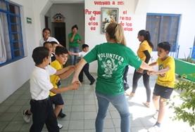 Care A childcare volunteer in Mexico leads children through an activity to help stimulate their physical development and promote teamwork.