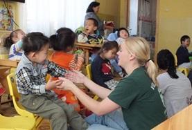 Mongolia Childcare volunteers in Mongolia work one-on-one with young children, playing educational and fun games.