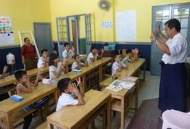Myanmar A childcare volunteer teaches students at a school for the deaf in Myanmar.