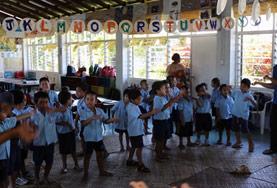 Samoa A volunteer working with children gives an English lesson to her class in Samoa.