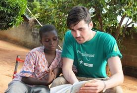 Togo A childcare volunteer reads to a boy in Togo, working on his English literacy skills.