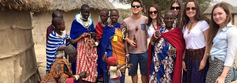 Care and Community volunteers visit Masai village in Tanzania Projects Abroad Care and Community volunteers stand with local Tanzanians at a Masai village