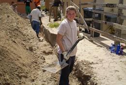 Building A High School Project Building volunteer assists with laying the foundation for a new house in South Africa.