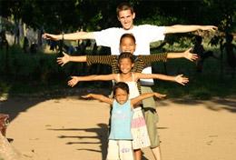 Cambodia A High School Project volunteer poses in a creative way with the children from his Care & Community placement in Cambodia.