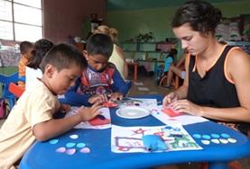 Ecuador A high school student volunteering in Ecuador runs an art class with children from a local care centre, teaching them new skills in a creative way.