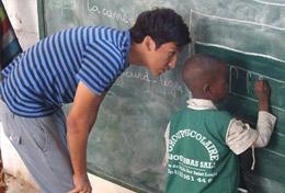 Senegal A high school student teaches a child how to write on a blackboard at his volunteer placement at a school in Senegal.