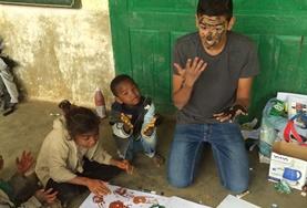 Madagascar A Care & Community volunteer has fun painting with local children in Madagascar over his high school vacation.