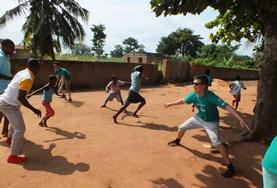Togo High School Project volunteers play a game with local children in Togo to help with their physical development and teamwork.