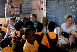 Ghana High school students volunteering in Ghana hold a creative, fun lesson with local children.