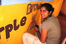 Sri Lanka A High School Project volunteer paints an educational mural at a school as part of her Care & Community work in Sri Lanka.