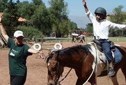 Bolivia A high school volunteer assists a local child with riding his therapy horse on our Equine Therapy & Community project in Bolivia.