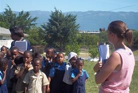 Jamaica A Disaster Management volunteer talks to local children about an evacuation plan at a school in Jamaica.
