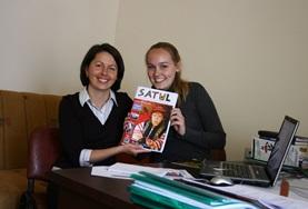 Romania A local journalist and a Journalism intern in Romania hold the magazine they have been working on together.