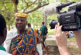 Togo A Journalism intern conducts an interview with a man for a local news broadcasting company in Togo.