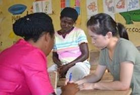 Language Courses A volunteer works through an activity with her Ga language tutors.