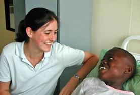 Ghana A Dentistry intern volunteering in Ghana spends time with a patient after a dental procedure.