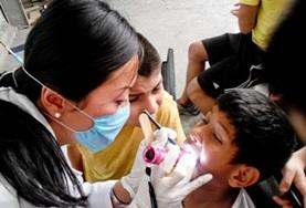 Medicine & Healthcare A Dentistry intern observes as a dentist performs a check-up on a boy in Guadalajara, Mexico.