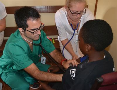 Spanish Medical volunteer assesses a young child at an outreach programme Projects Abroad Medicine volunteer from Spain doing health checks with children at a medical outreach programme in the Knockpactrick community of Manchester, Jamaica
