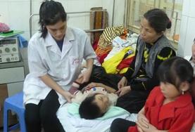 Vietnam Medical interns in Vietnam help with caring for a patient in a local hospital.