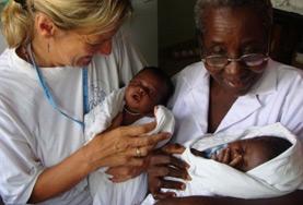 Ghana A Midwifery volunteer and a medical staff member hold two babies delivered in the maternity department of a hospital in Ghana.