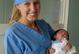 Mongolia A Midwifery intern volunteering in the maternity department of a Mongolian hospital holds a newborn baby.