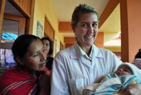 Peru A Midwifery intern holds a newborn baby at her volunteer placement in Peru.