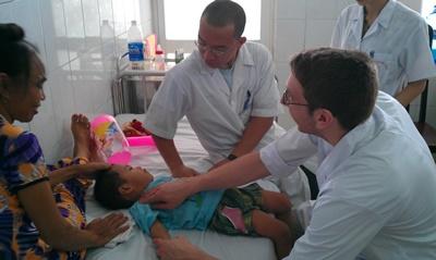 Volunteers treat boy Projects Abroad Vietnam medical volunteers treat young boy in hospital
