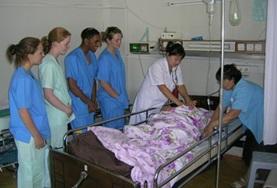 Mongolia Nursing interns in Mongolia observe as local doctors insert an IV into a patient as part of her treatment.