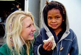 Medicine & Healthcare A Nutrition volunteer doing her internship in South Africa talks to a child about the importance of healthy eating.
