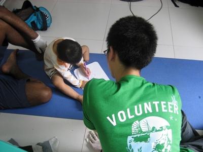 A physiotherapy volunteer working with a child at a rehabilitation centre in Philippines A Projects Abroad occupational therapy volunteer works with a child at a rehabilitation centre