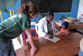 Medicine & Healthcare A local occupational therapist demonstrates an assessment technique to a Medical intern in Tanzania.