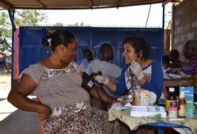 Ghana A Pharmacy intern volunteering at an outreach in Ghana helps with distributing medicine to local patients.