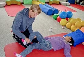 Bolivia A volunteer works on strengthening a disabled child's muscles at our Physiotherapy internship in Bolivia.