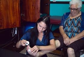 Costa Rica A Physiotherapy intern works with an elderly patient in Costa Rica, stretching her muscles and helping to strengthen her legs.