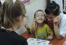 Vietnam A Speech Therapy volunteer works on a language task with a disabled boy at our internship in Vietnam.
