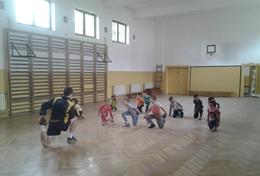 Romania A Soccer volunteer leads a sports team in Romania through a stretching routine before they start their practice.
