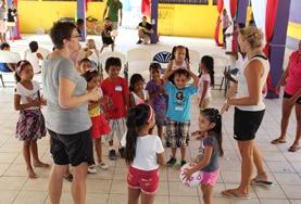 Belize School Sports volunteers play a ball game with young children in Belize to promote physical development and fitness.