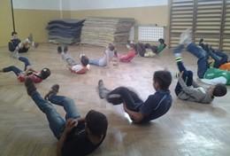 Romania A School Sports volunteer leads a stretching class during a physical education lesson with school children in Romania.
