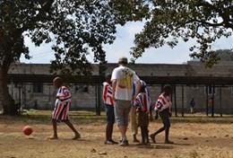 Sports A volunteer coaches a group of students during a school sports lesson in Tanzania.