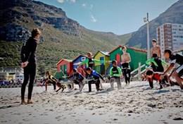 Sports A volunteer works with local children on their surfing technique during a lesson in South Africa.