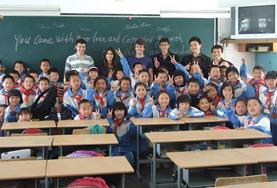 Teaching A Teaching volunteer poses with her class from a local school in China.